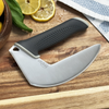 NULU kitchen knife resting on a wooden cutting board beside lemon slices and a patterned kitchen towel