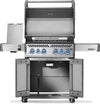 Napoleon Rogue PRO-S 525 grill with lid raised, side burner cover open and double-door storage cabinet open