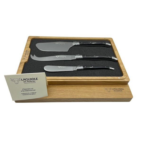 Laguiole en Aubrac three-piece cheese knife set in a wooden tray, with the box lid and authenticity certificate alongside