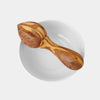 Close-up of deep ridges on hand-carved olive wood reamer head for maximum citrus juice extraction