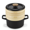 Black Alva Dutch oven with two stacked bamboo steamer baskets and a black lid with a gold-toned knob