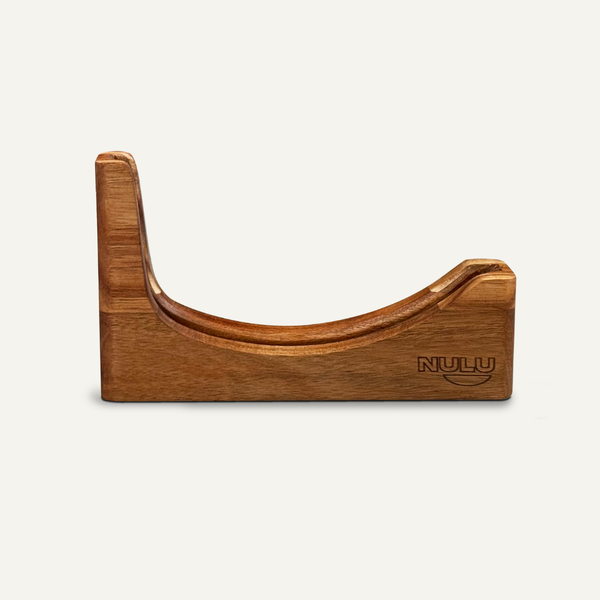 “Front view of an empty acacia NULU knife dock with a curved blade slot and engraved logo.”