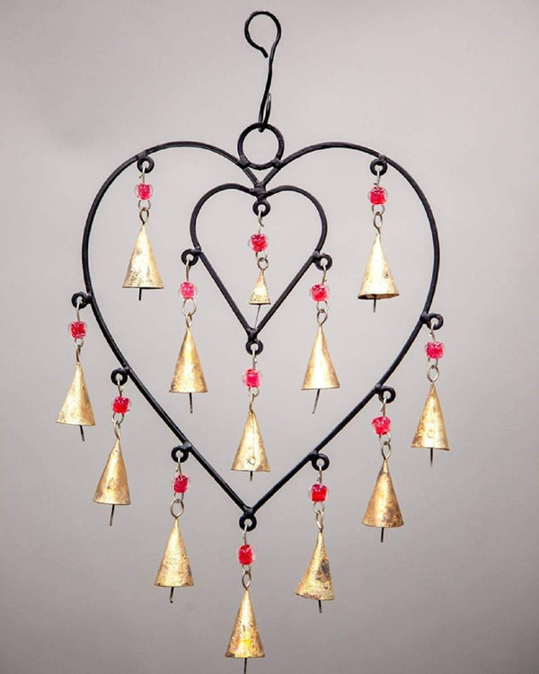 13-inch handcrafted heart chime bell hanging against a wall, artisan wall art for sanctuary spaces