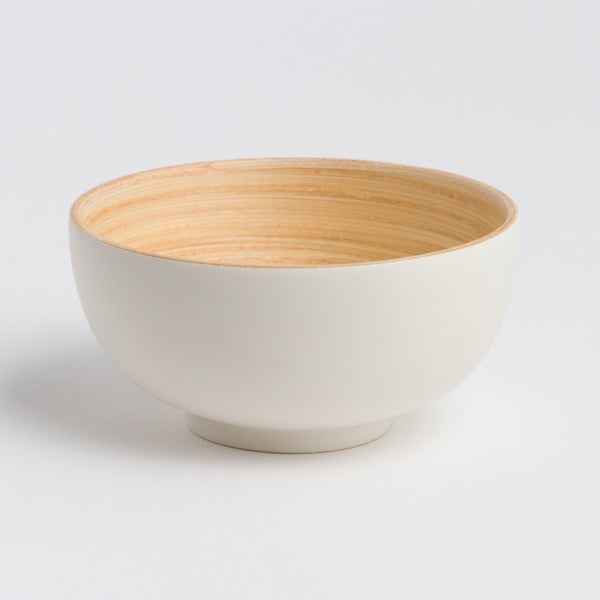 White ceramic bowl with wooden interior on a light gray background