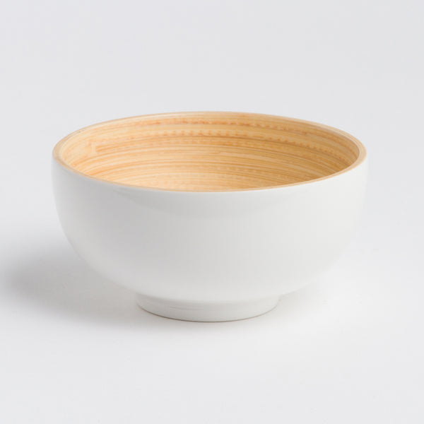 White ceramic bowl with a wooden interior on a light gray background