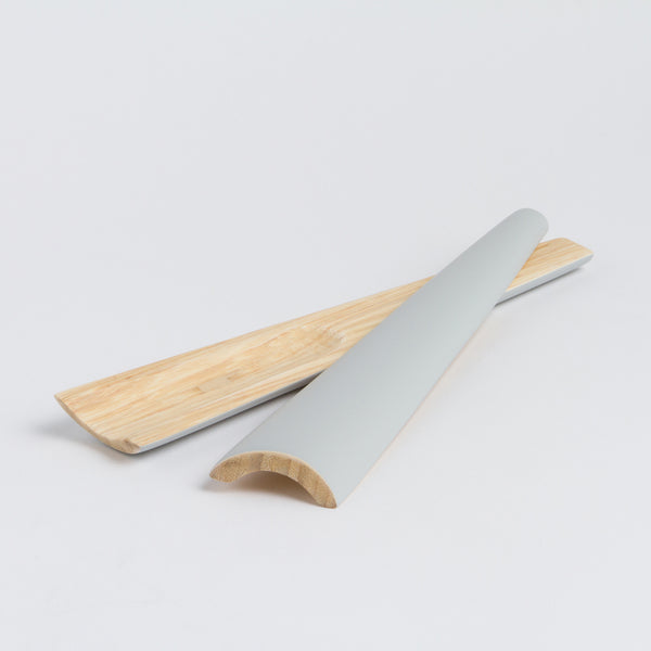 "Close-up detail of the smooth ergonomic handle and artisanal finish of TIA servers"