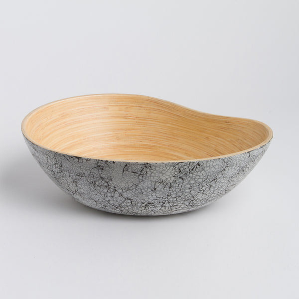 Bowl with gray marble exterior and wooden interior on a light gray background