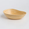 Close-up of functional pouring spout on SOAI artisan bamboo bowl, sustainable fair trade serveware."