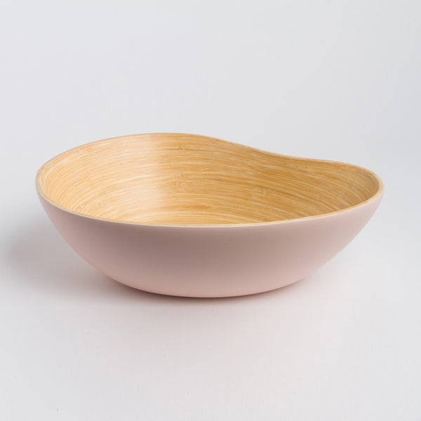 Bowl with beige interior and pink exterior on a light gray background