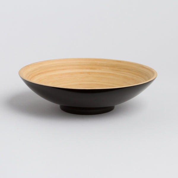 Bowl with black base and wooden top on a light gray background