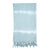 Ocean tie dye Turkish beach towel with hand-knotted tassels laid out on sand