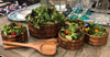 Handcrafted acacia wood serving bowl filled with salad, paired with wooden servers for elegant hosting