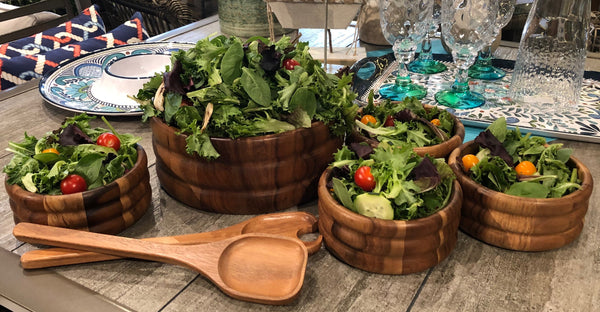 Handcrafted acacia wood serving bowl filled with salad, paired with wooden servers for elegant hosting