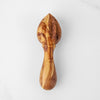 Close-up of deep ridges on hand-carved olive wood reamer head for maximum citrus juice extraction
