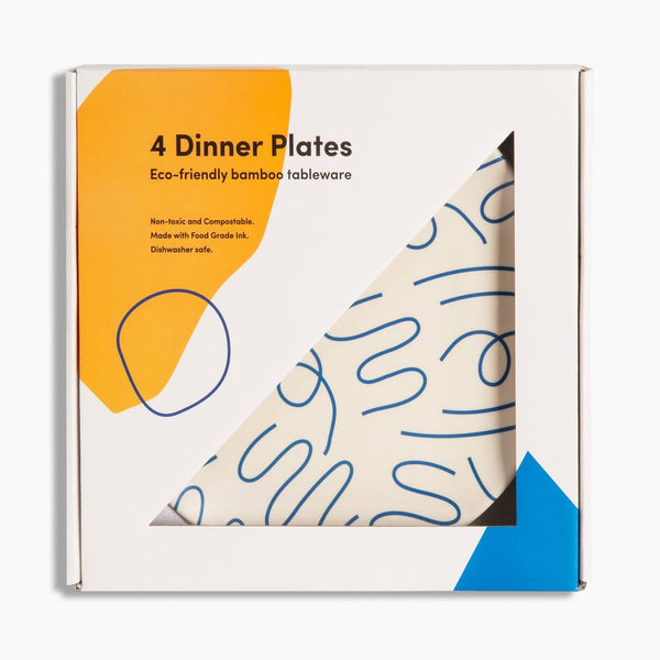 Packaging of 4 eco-friendly bamboo dinner plates with abstract blue line design on a white background.