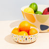 Bamboo fiber serving bowls arranged on a dining table with fresh food, sustainable kitchen serving set