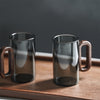 Set of transparent and ash-grey glass mugs with dark walnut handles