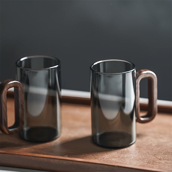 Set of transparent and ash-grey glass mugs with dark walnut handles