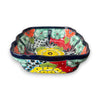 Colorful ceramic bowl with floral patterns on a white background