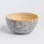 "Close-up of the artisanal finish and bamboo grain on the small TCHON bowl"