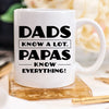 White mug with humorous text on a wooden coaster
