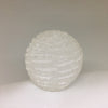 Close-up of translucent natural selenite crystal fibers and hand-cut bubble lamp texture