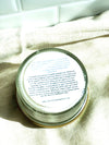 Jar lid with text on a beige fabric background