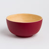 Red and beige ceramic bowl on a light gray background