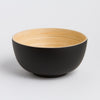Black and beige ceramic bowl on a light gray background